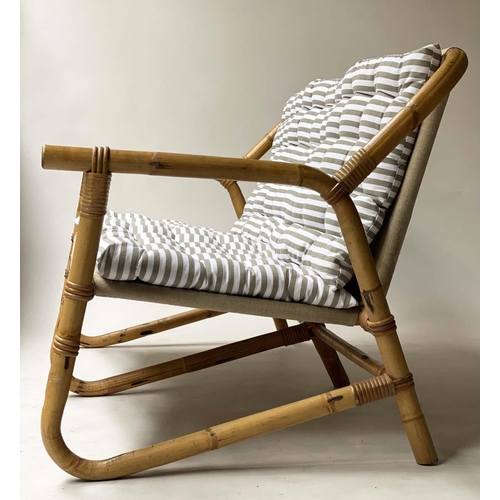 618 - BAMBOO SOFA, framed and cane bound with canvas and striped cushions, 124cm W.