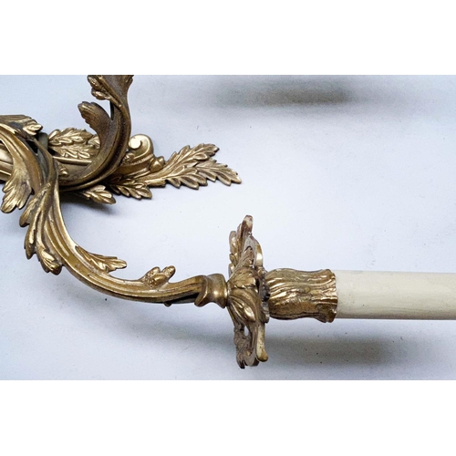 387 - WALL LIGHTS, a set of three, Louis XV style gilt metal each two branch, 40cm H. (3)