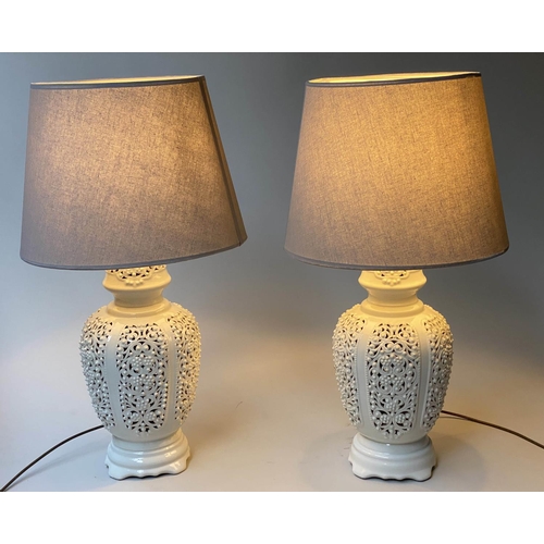 519 - TABLE LAMPS, a pair, reticulated white ceramic of vase form with shades, 76cm H. (2)