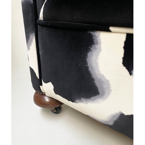 520 - ARMCHAIR, Howard style black and white printed velvet with scroll arms and bun front supports, 86cm ... 