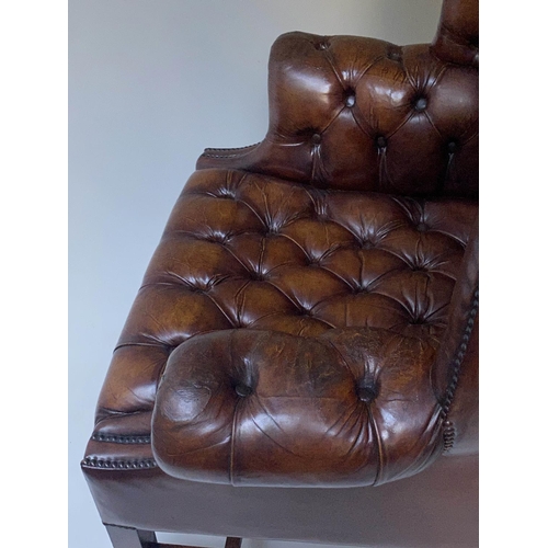 503 - WING ARMCHAIR, 84cm W, George III design buttoned brown leather, with scroll arms and stretchered su... 