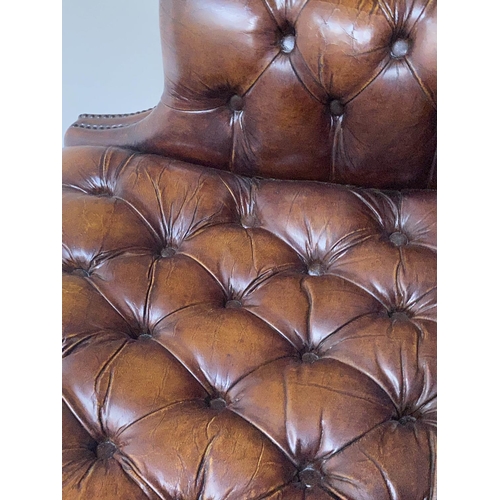 503 - WING ARMCHAIR, 84cm W, George III design buttoned brown leather, with scroll arms and stretchered su... 