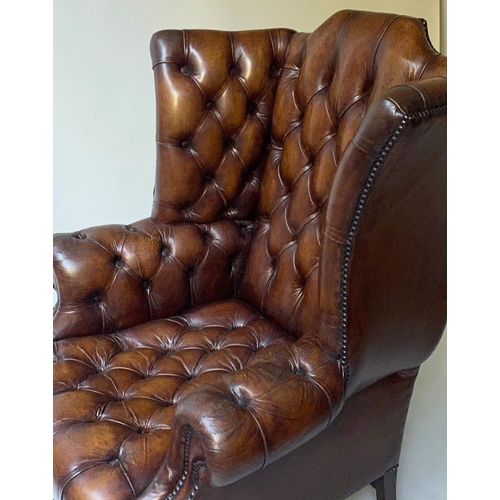 503 - WING ARMCHAIR, 84cm W, George III design buttoned brown leather, with scroll arms and stretchered su... 