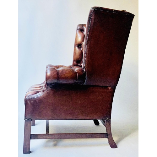 503 - WING ARMCHAIR, 84cm W, George III design buttoned brown leather, with scroll arms and stretchered su... 