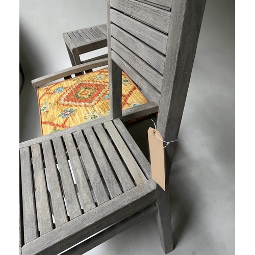 476 - GARDEN CHAIRS, a pair, weathered teak with a cushioned stool, 62cm x 53cm x 40cm H. (3)