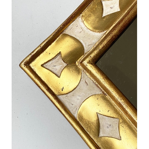 466 - HARRISON GIL WALL MIRROR, antiqued gilded and painted, extended lozenge with bevelled mirror and scr... 