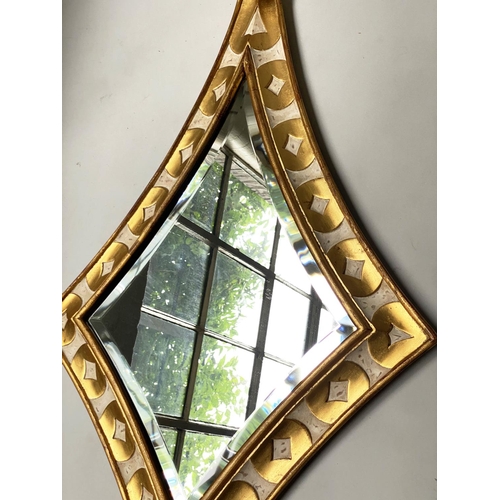 466 - HARRISON GIL WALL MIRROR, antiqued gilded and painted, extended lozenge with bevelled mirror and scr... 