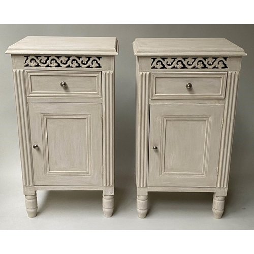 395 - BEDSIDE CHESTS, a pair, French style, traditionally grey painted and pierced, each with drawer and d... 