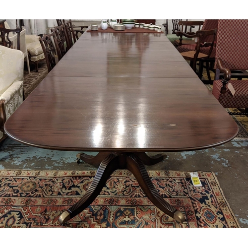 570 - TRIPLE PEDESTAL DINING TABLE, Georgian style mahogany with two leaves and brass castors, extended 49... 