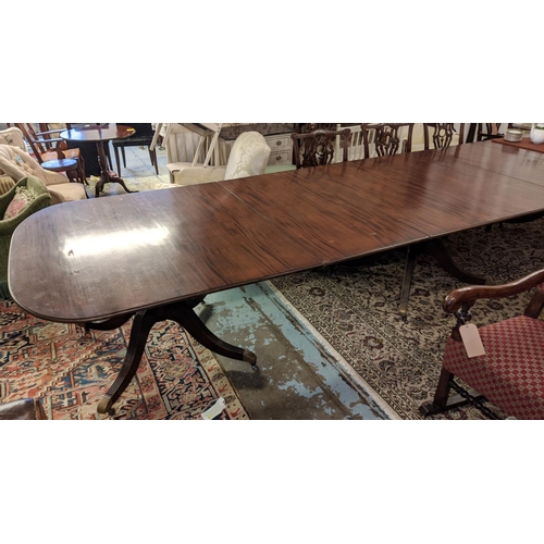 570 - TRIPLE PEDESTAL DINING TABLE, Georgian style mahogany with two leaves and brass castors, extended 49... 