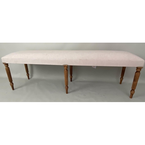 241 - HALL SEAT, neutral upholstered reeded supports, 151cm x 40cm x 49cm.