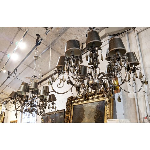 554 - CHANDELIERS, a pair, silvered metal with twelve lights, flower motifs and hanging glass drops, 82cm ... 