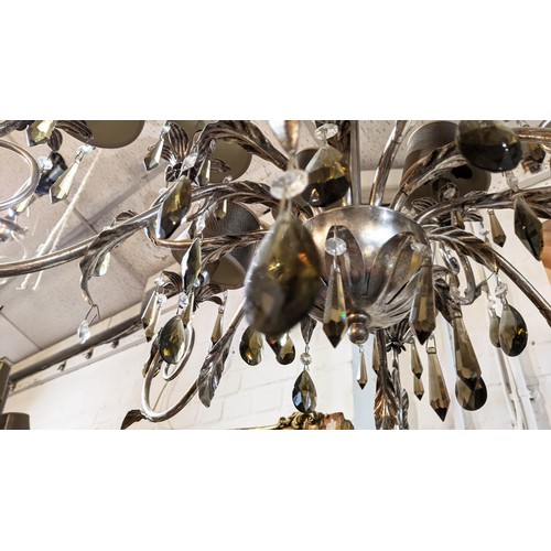 554 - CHANDELIERS, a pair, silvered metal with twelve lights, flower motifs and hanging glass drops, 82cm ... 