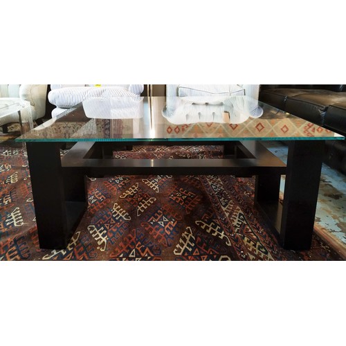 557 - LOW TABLE, 42cm H x 105cm W, ebonised with square glass top.