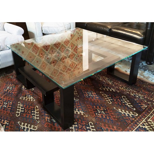 557 - LOW TABLE, 42cm H x 105cm W, ebonised with square glass top.