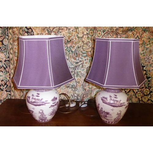 511 - TABLE LAMPS, a pair, 48cm H each decorated with figures and purple cream bordered shades and a pair ... 