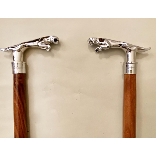 129 - WALKING STICKS, a pair, silver jaguar walnut cane. (2)