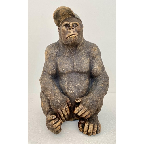 169 - GORILLA WEARING CAP, resin cast, 58cm x 40cm x 34cm.