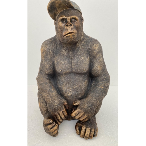 169 - GORILLA WEARING CAP, resin cast, 58cm x 40cm x 34cm.