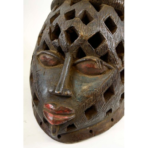 368 - PIERCED IGBO MASKS, a pair, Nigeria, carved wood, hand painted, 30cm x 33cm. (2)