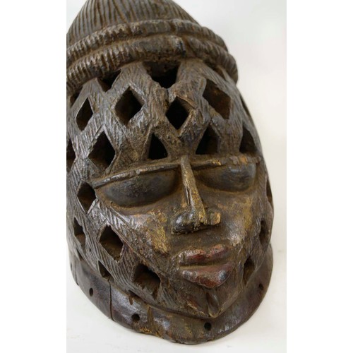 368 - PIERCED IGBO MASKS, a pair, Nigeria, carved wood, hand painted, 30cm x 33cm. (2)