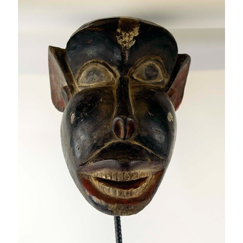 370 - BAMOUR MASK, carved and painted wood on a metal stand with a wooden base, Cameroon, 100cm x 33cm.