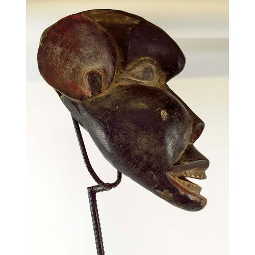 370 - BAMOUR MASK, carved and painted wood on a metal stand with a wooden base, Cameroon, 100cm x 33cm.