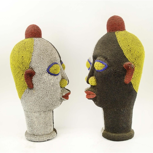 131 - IFEE TERRACOTTA BEADED HEADS, a pair, Nigerian, black, white, yellow, red and blue beads, 45cm H. (2... 