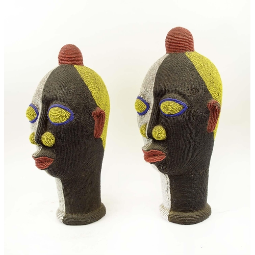 131 - IFEE TERRACOTTA BEADED HEADS, a pair, Nigerian, black, white, yellow, red and blue beads, 45cm H. (2... 