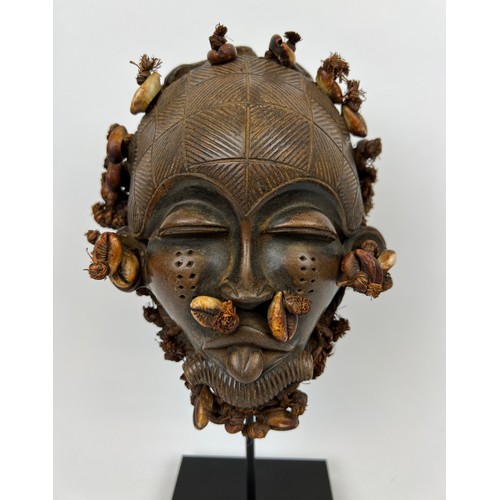 114 - MALI TERACOTTA MASK, decorated with cowery shells, on stand. 31cm H