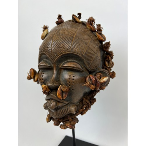 114 - MALI TERACOTTA MASK, decorated with cowery shells, on stand. 31cm H