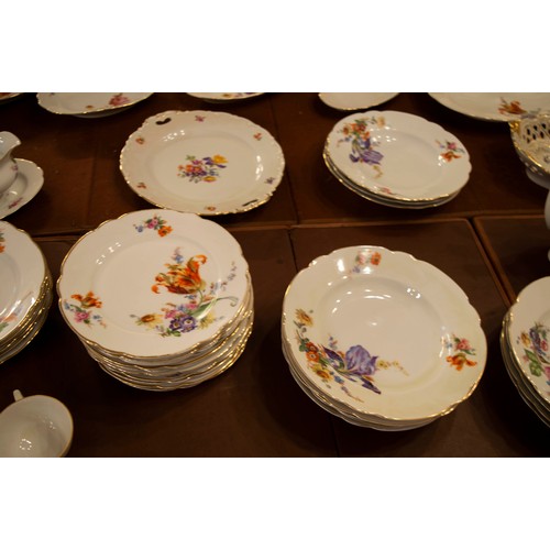 135 - PART DINNER SERVICE, comprising twelve hand painted foliate KPM soup bowls, nine dinner plates, two ... 