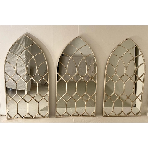 586 - ARCHITECTURAL WALL MIRRORS, a set of three, 132cm x 66cm, aged white painted finish. (3)