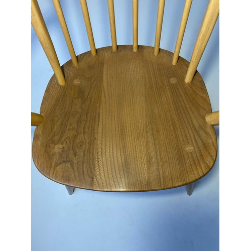 429 - ERCOL WINDSOR DINING CHAIRS, a set of four elm stick hoop back armchairs with solid seats (all label... 