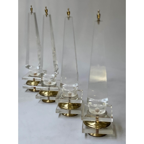 247 - TABLE OBELISKS, a set of four, 42cm H, Lucite, of tapering form on gilded bases. (4)