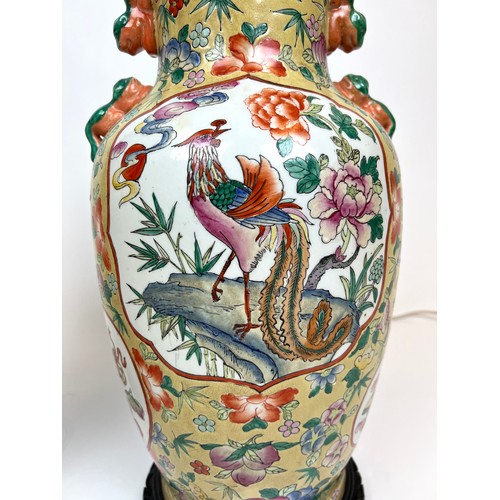 296 - CHINESE VASE LAMPS, a pair, Chinese hand painted ceramic with carved hardwood bases, 61cm H. (2)