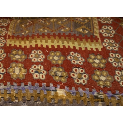 256 - KILIM SOFA, 186cm x 94cm, three seater with turned feet and brass castors.