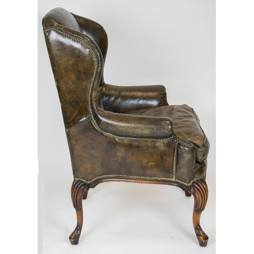 275 - WING ARMCHAIR, 111cm H x 84cm, Georgian style in brown leather.