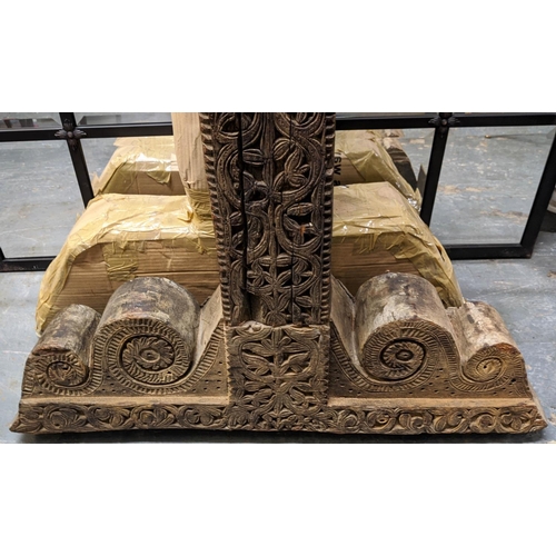 421 - ARCHITECTURAL BALINESE CARVED COLUMNS, a pair, 223cm H.