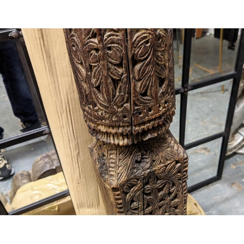421 - ARCHITECTURAL BALINESE CARVED COLUMNS, a pair, 223cm H.