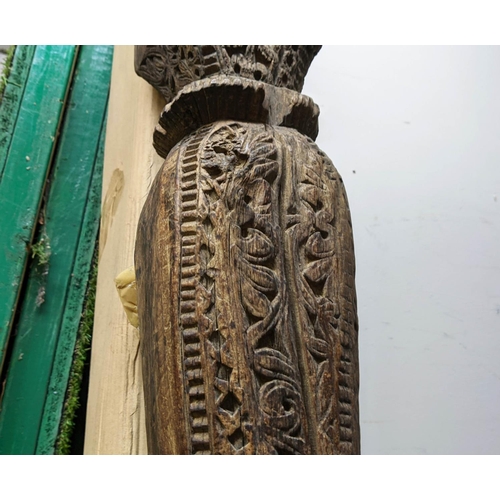 421 - ARCHITECTURAL BALINESE CARVED COLUMNS, a pair, 223cm H.