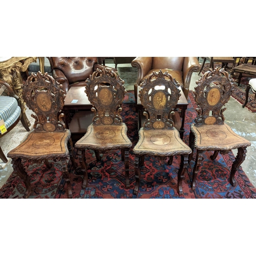 287 - HALL CHAIRS, a set of four, 19th century Swiss walnut with carved backs and marquetry detail. (4)