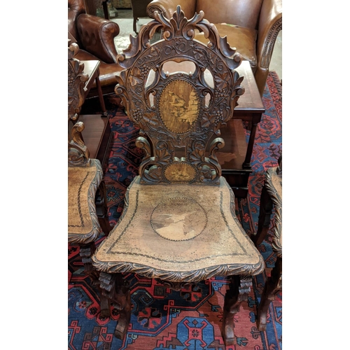 287 - HALL CHAIRS, a set of four, 19th century Swiss walnut with carved backs and marquetry detail. (4)