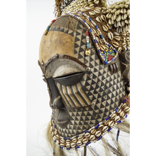 115 - KUBA MASK, Congolese, carved wood, painted and adorned with Cowrie shells and beads 65cm H