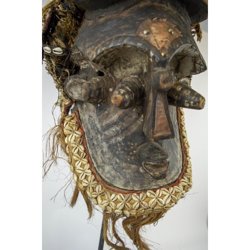 116 - KUBA MASK, Congolese, ornately carved wood, adorned with Cowrie shells and grass fiber 90cm H