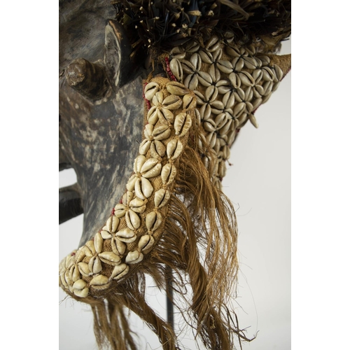 116 - KUBA MASK, Congolese, ornately carved wood, adorned with Cowrie shells and grass fiber 90cm H