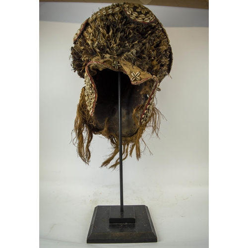 116 - KUBA MASK, Congolese, ornately carved wood, adorned with Cowrie shells and grass fiber 90cm H