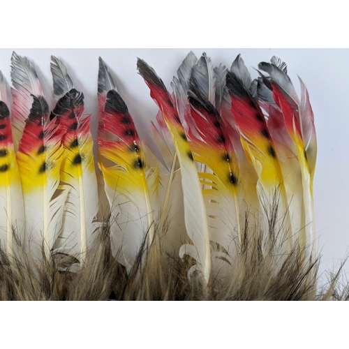 552 - CHIEF FEATHERED HEAD PIECE, a pair, recent production, late 20th century. (2)