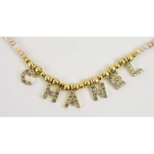 99 - LADIES CHANEL NECKLACE, small size, freshwater pearl chain, letters set with paste diamonds, gilt me... 