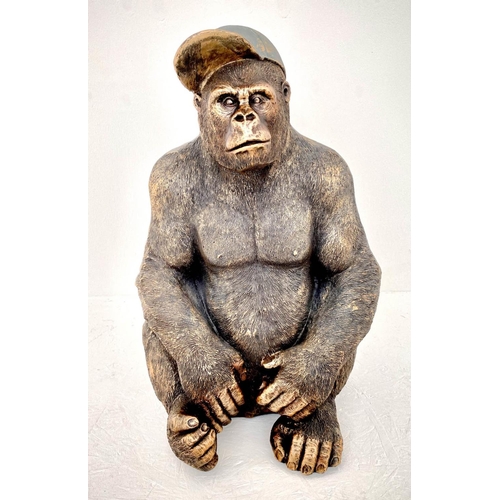 579 - GORILLA WITH HIS BASEBALL CAP, contemporary school sculptural study, faux bronze, 54cm H.